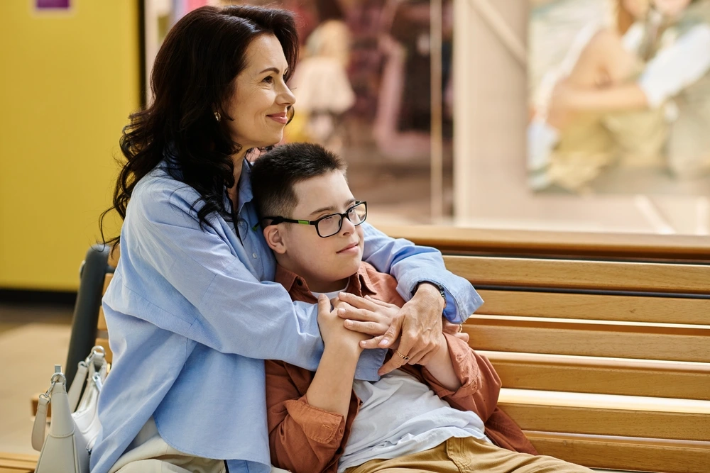 Mum hugging disabled boy